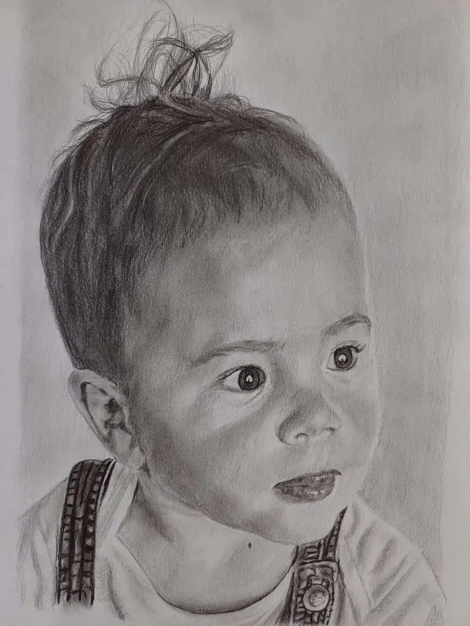 Retrato a lápiz de un niño pequeño con el pelo despeinado y mirada expresiva